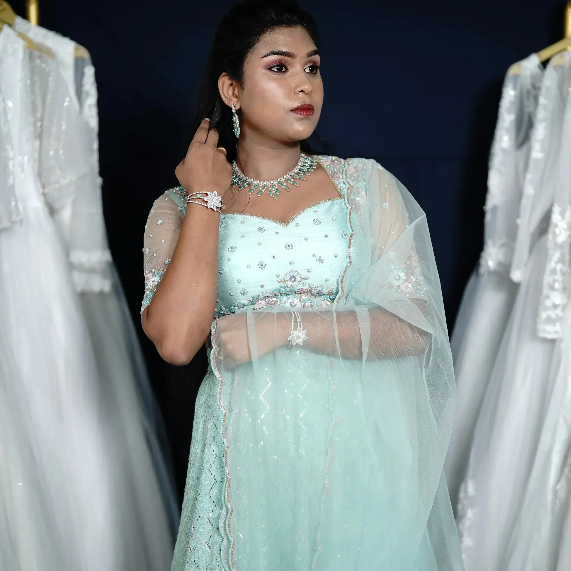 Bride in light green crop top lehenga with sheer dupatta and jewelry, wedding dress rental, bridal dress rental, elegant bridal styling