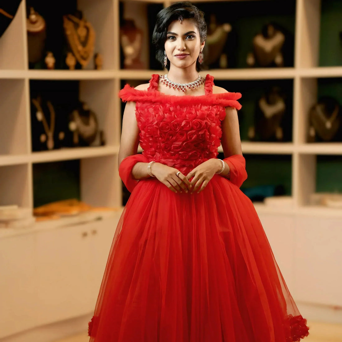 Elegant woman wearing red designer wedding gown in bridal studio, stylish wedding dress rental in Kochi, luxury wedding gown rental look, perfect choice to rent your wedding dress, modern bridal fashion and rent bridesmaid dresses inspiration.