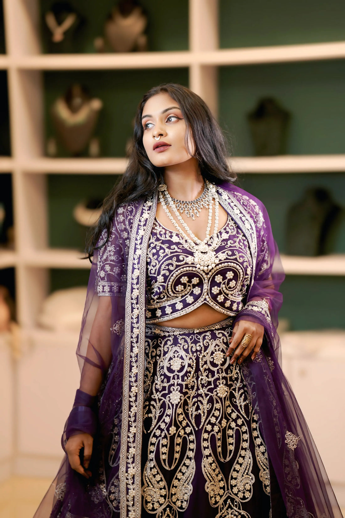 Bride in purple embroidered bridal lehenga with dupatta and jewelry, wedding dress rental, bridal dress rental, elegant bridal styling