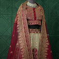 Traditional embroidered outfit on a mannequin against a green tiled wall