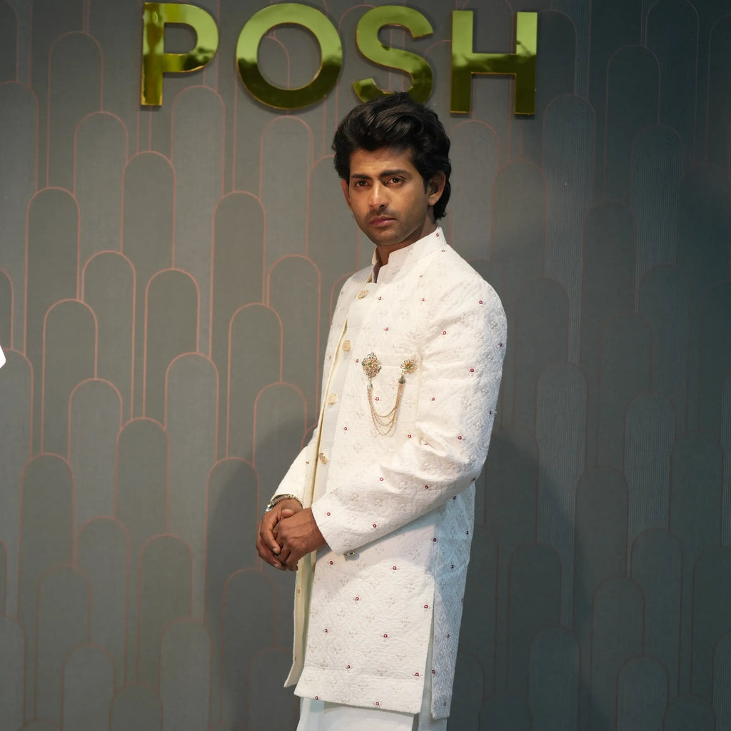 groom wearing rented Ivory White Indo-Western Set from posh wedding rental