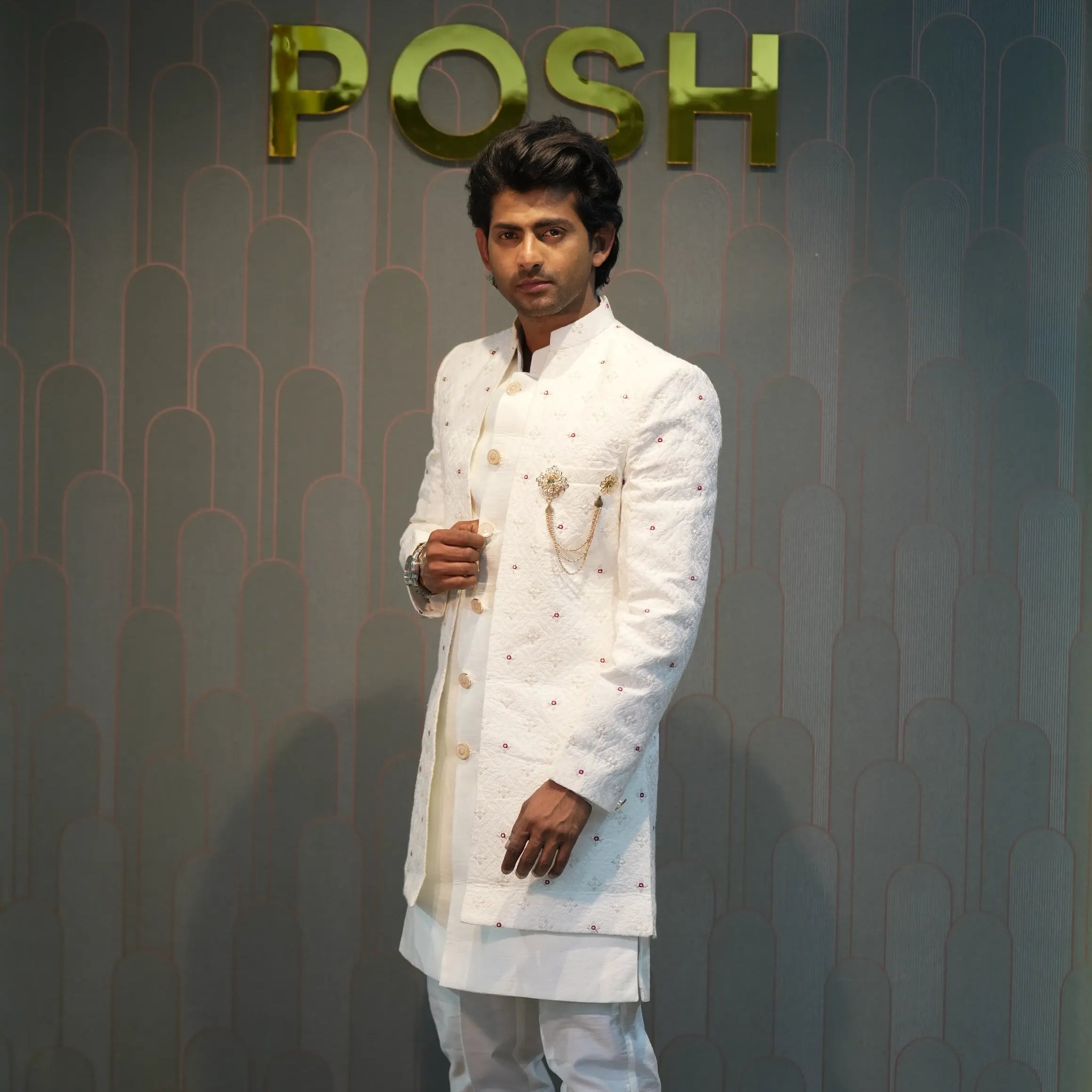 groom wearing rented Ivory White Indo-Western Set from posh wedding rental