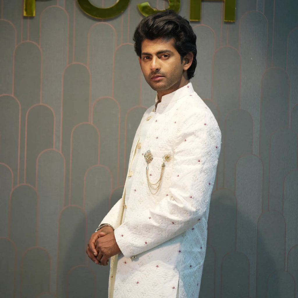 groom wearing rented Ivory White Indo-Western Set from posh wedding rental