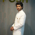 groom wearing rented Ivory White Indo-Western Set from posh wedding rental