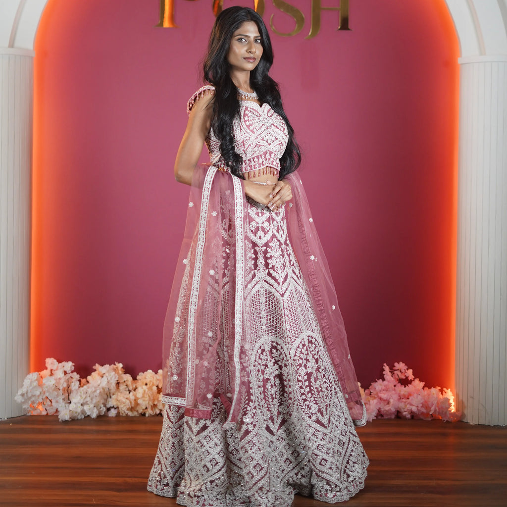 dusty rose designer bridal lehenga with heavy embroidery available at Posh Wedding Rental Kerala bridal lehenga rental