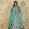 women wearing Aqua Blue Bridal Lehenga rented by posh wedding rental