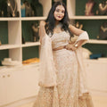 women wearing light pink embroidered lehenga 