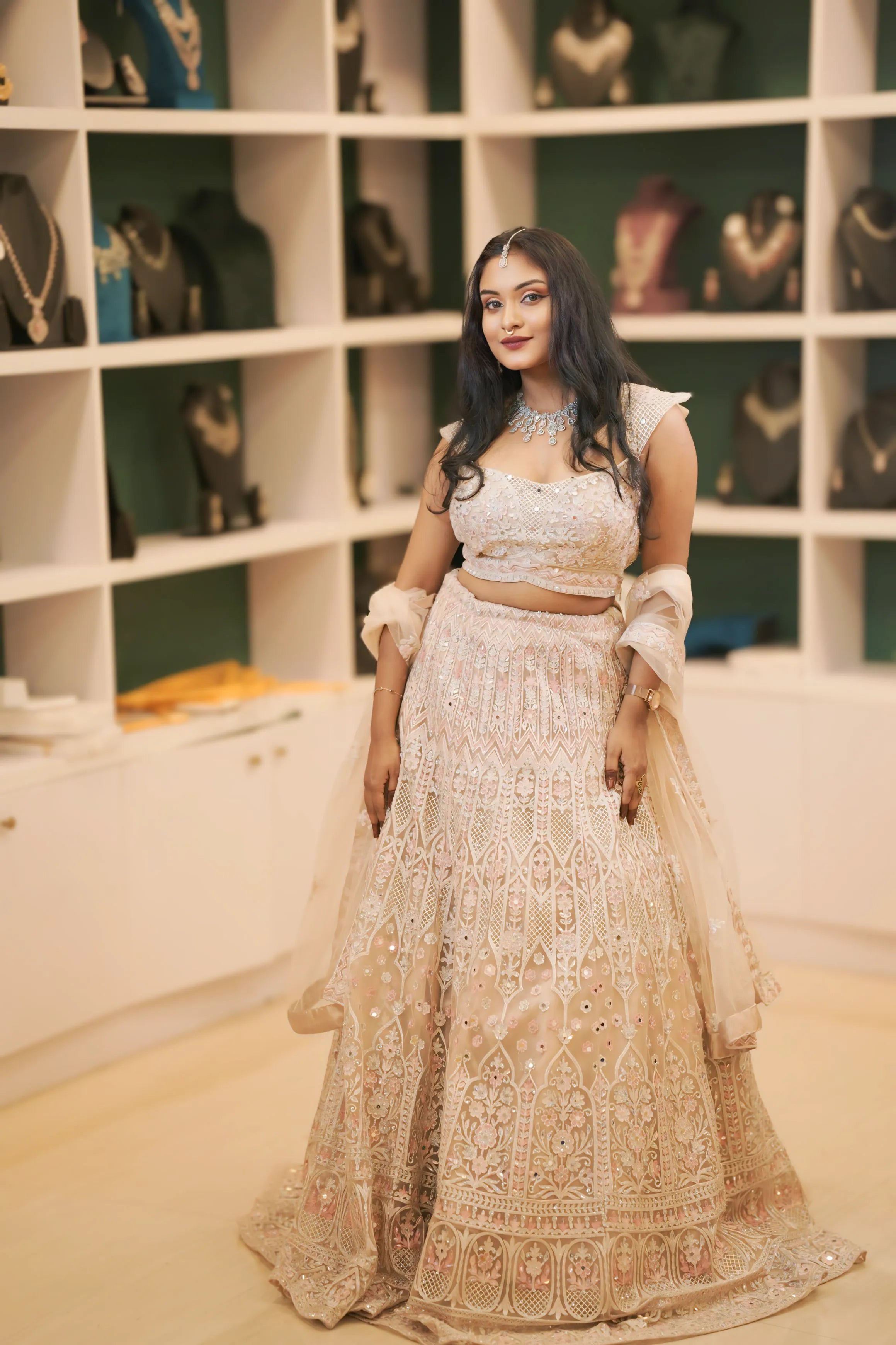 women wearing light pink embroidered lehenga 