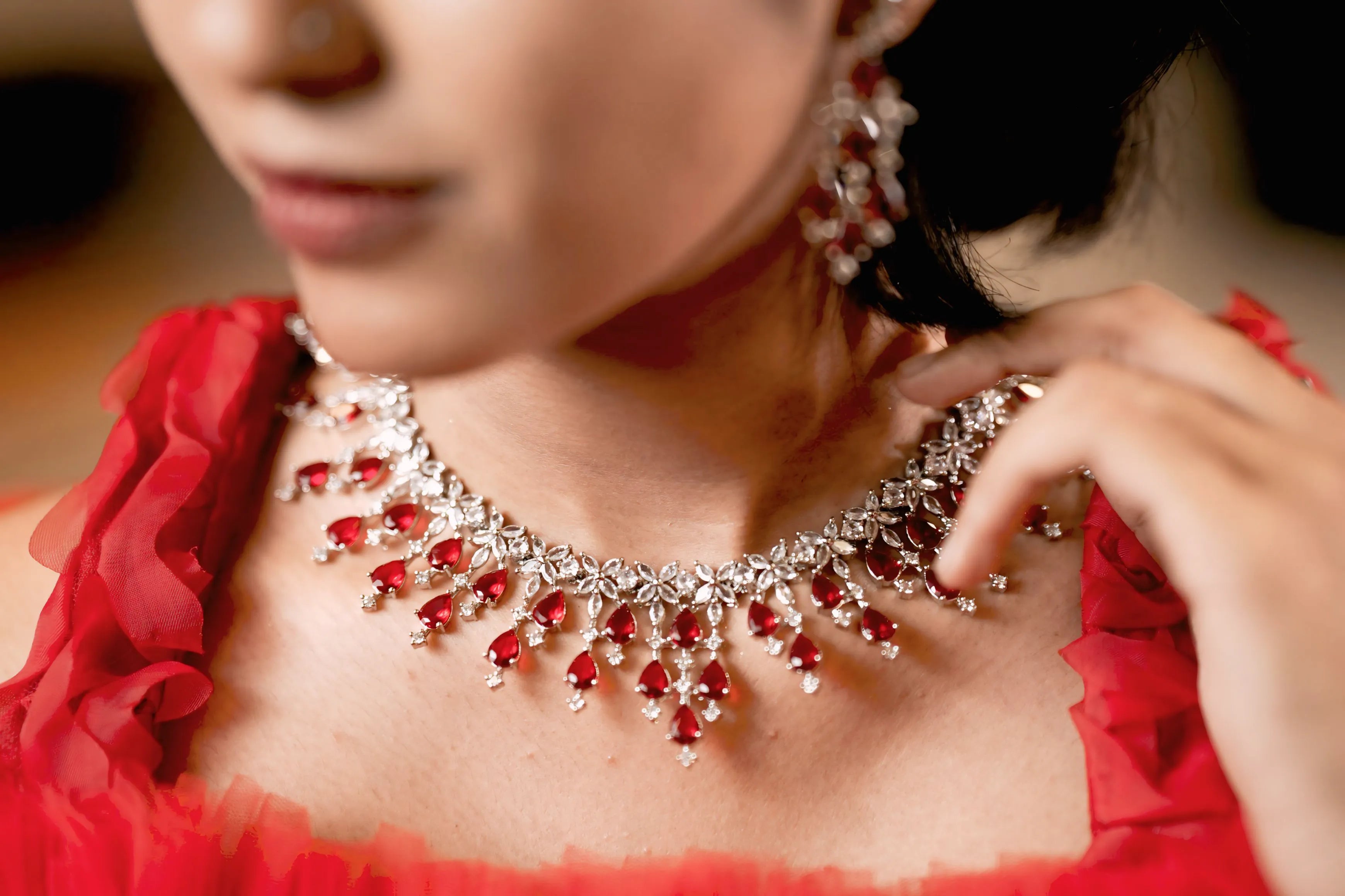 women showing red jewelry
