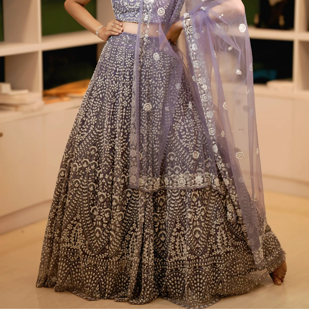 Woman in a Lavender Lehenga with a blurred indoor background