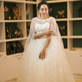 White Off-Shoulder Bridal Gown with Cape Overlay