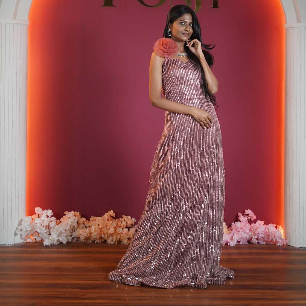rose gold sequin evening gown with floral shoulder detail available at Posh Wedding Rental Kerala gown rental