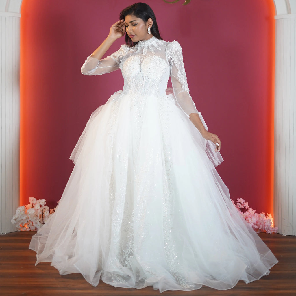 white high neck bridal ball gown with sheer sleeves available at Posh Wedding Rental Kerala bridal gown rental