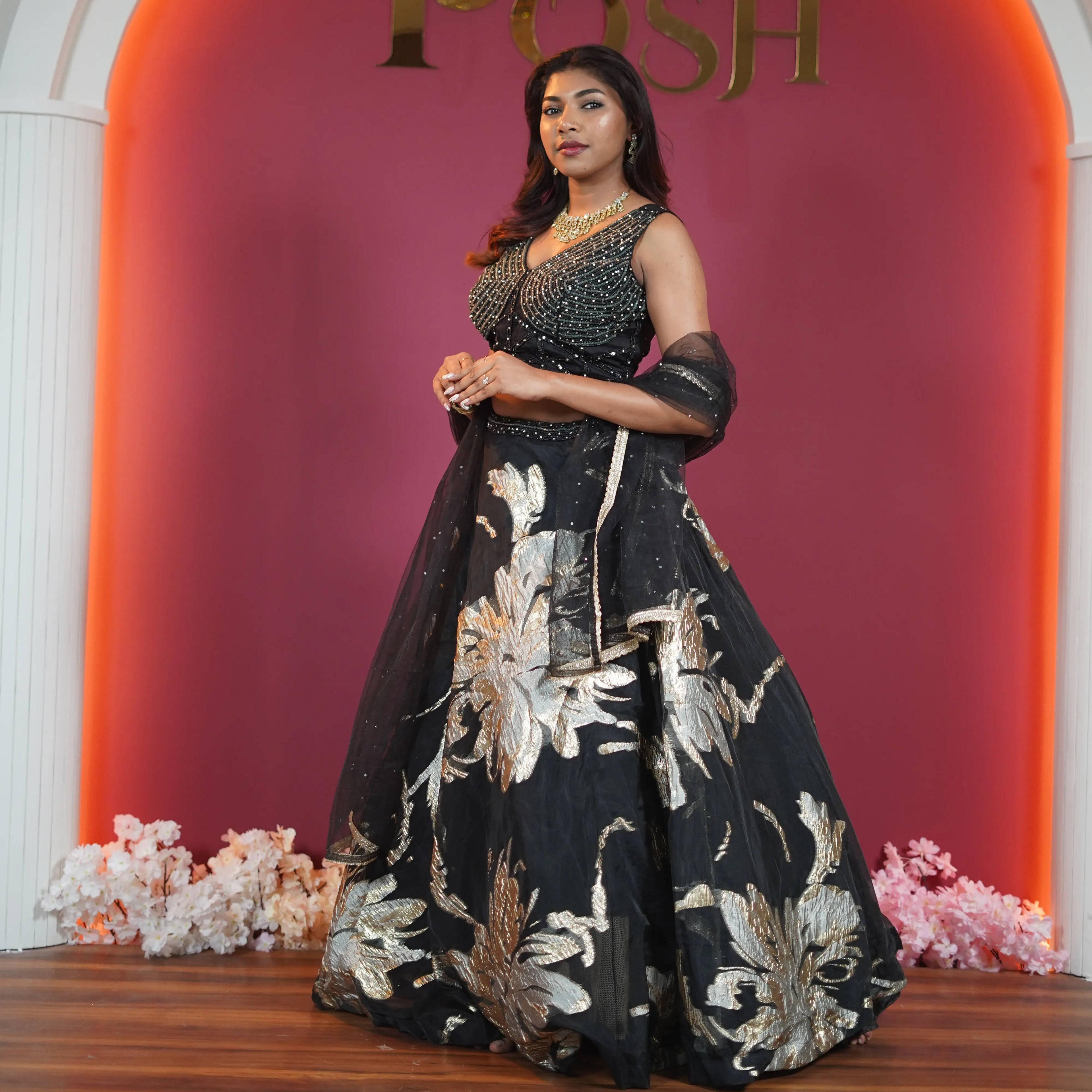 Luxury black bridal lehenga for rent in Kerala featuring gold embroidery by Posh Wedding Rentals.