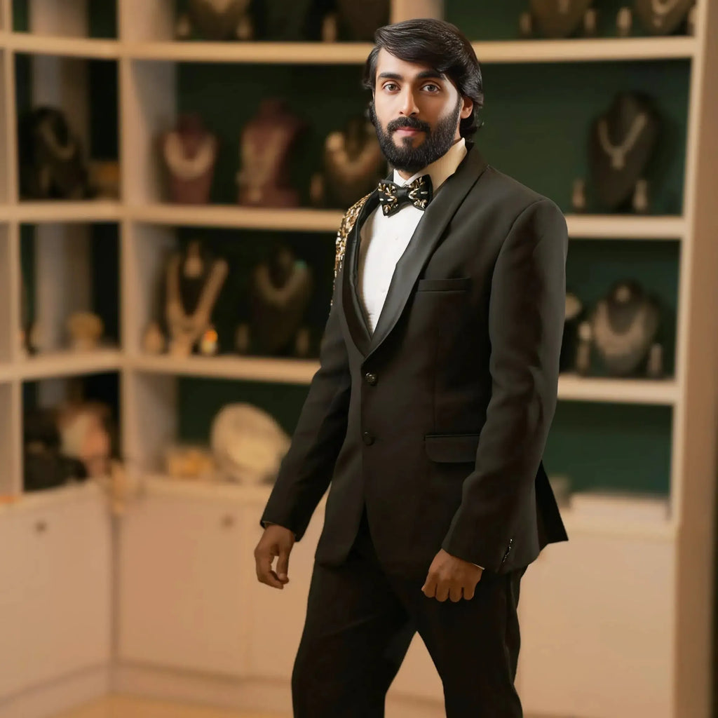man wearing black designer tuxedo suit with embroidered shoulder detail