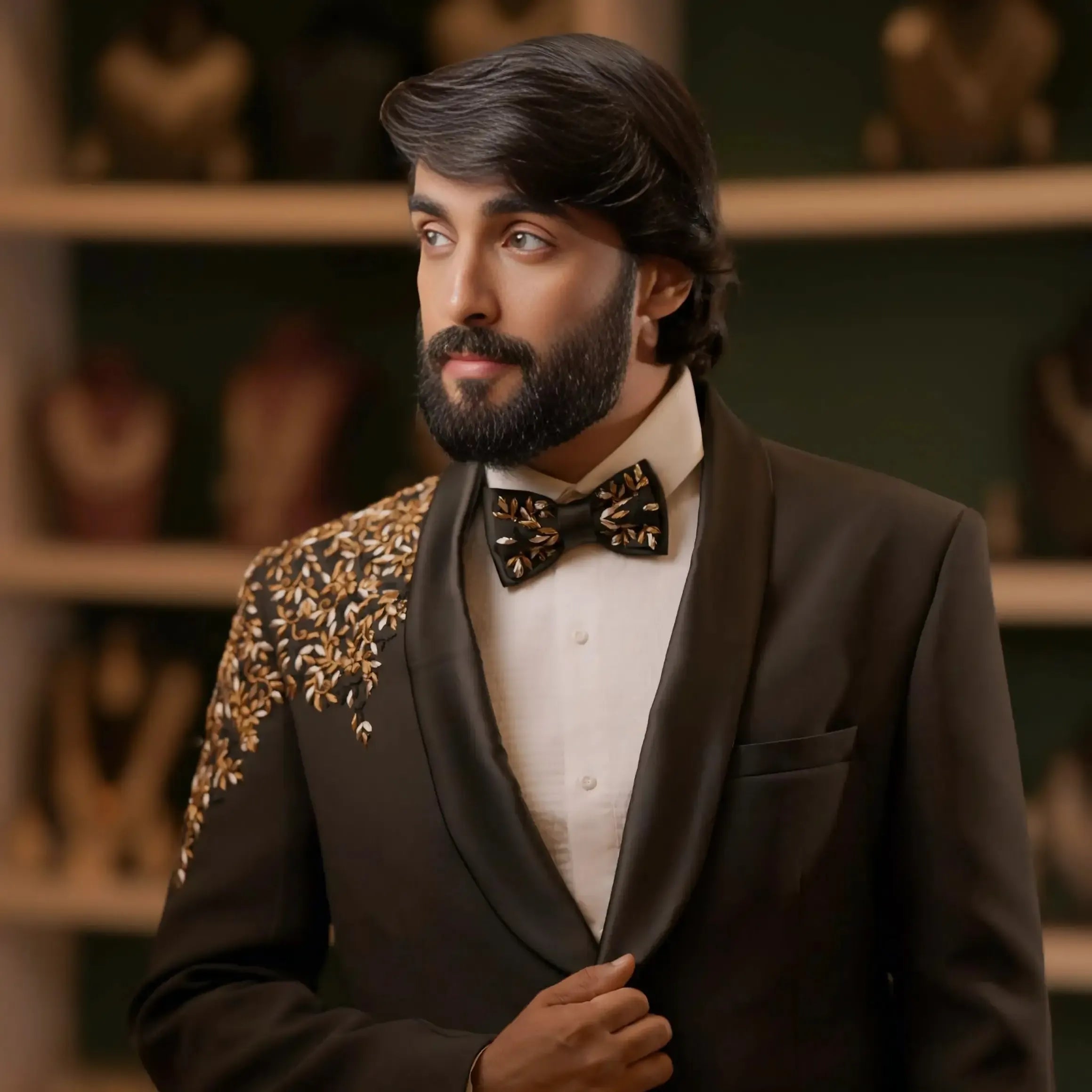 groom formal look in black tuxedo with bow tie for reception