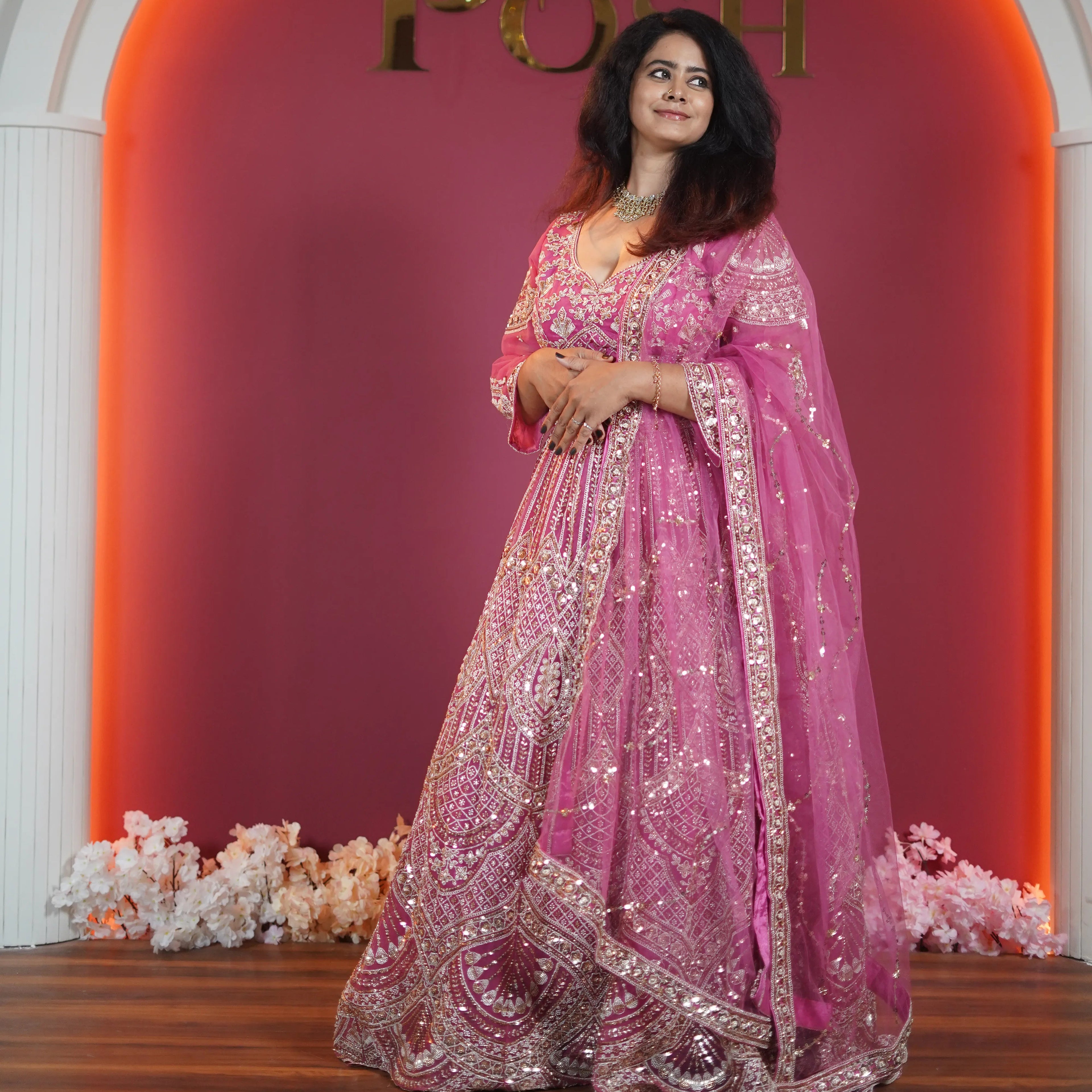 Pink designer bridal lehenga with heavy gold embroidery available on rent at Posh Wedding Rentals Kerala.