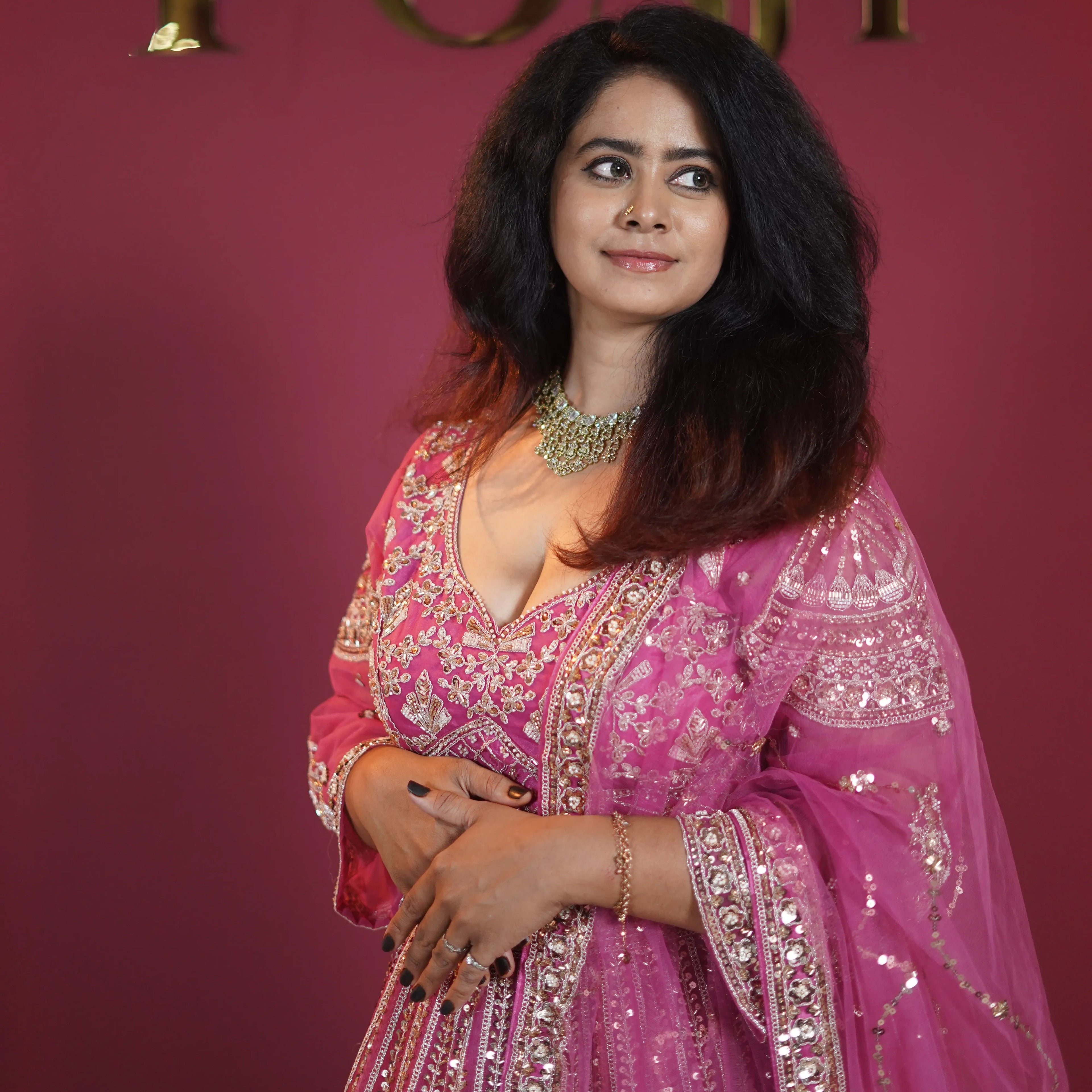 Pink designer bridal lehenga with heavy gold embroidery available on rent at Posh Wedding Rentals Kerala.