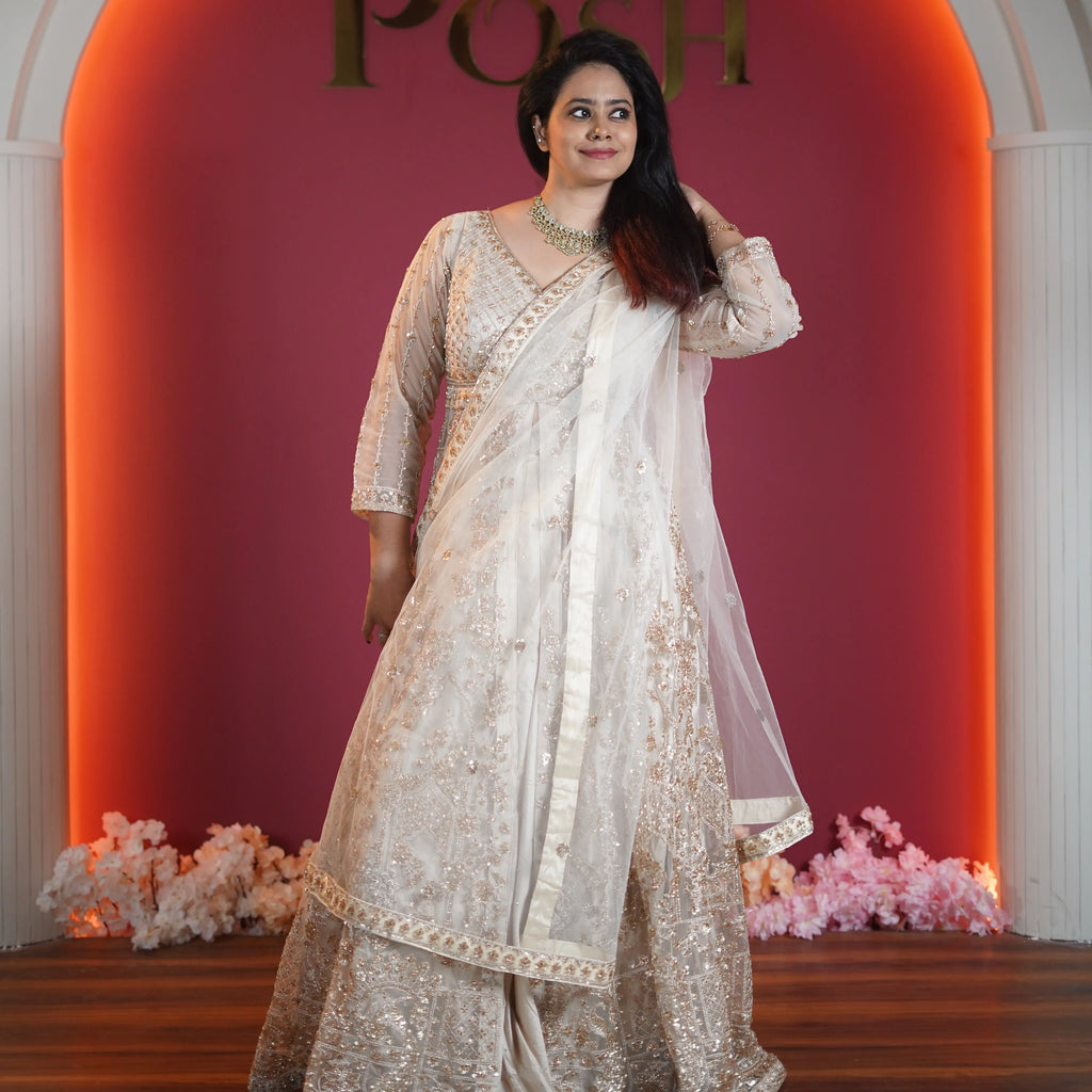 ivory embroidered bridal lehenga with net dupatta available at Posh Wedding Rental Kerala