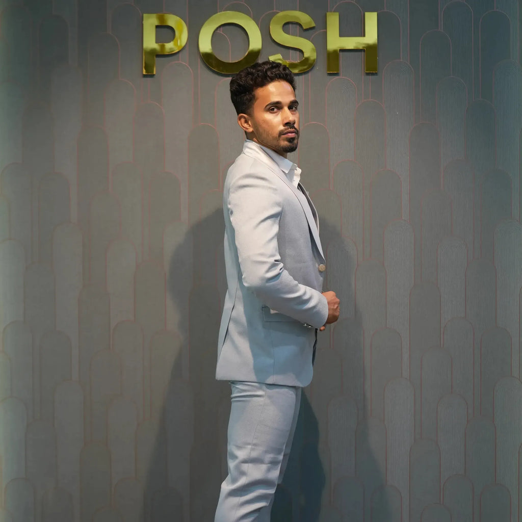 Light grey three-piece wedding suit with chain brooch