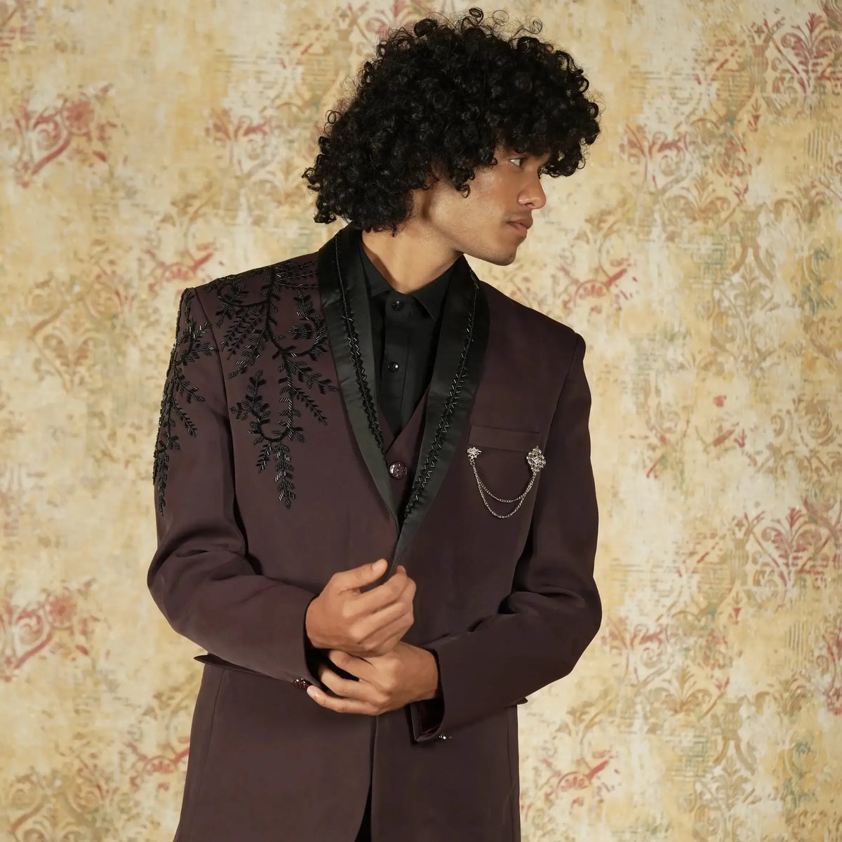 Maroon groom suit for wedding reception with designer detailing