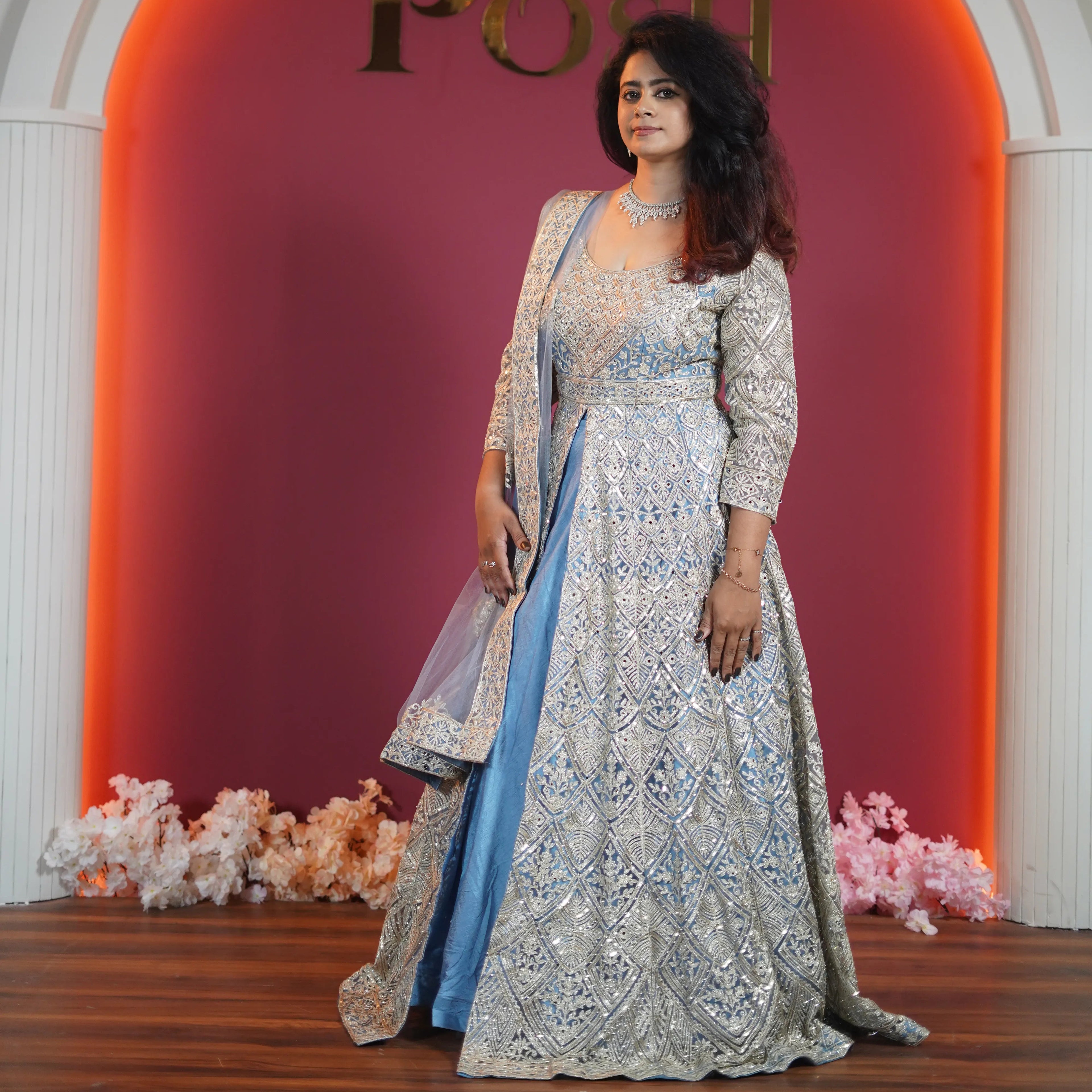 Elegant bride in pastel blue designer Anarkali with heavy silver embroidery from Posh Wedding Rentals premium collection.