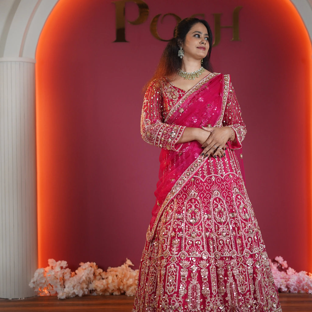 hot pink designer crop top lehenga with gold embroidery available at Posh Wedding Rental Kerala